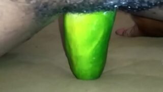 A horny solo girl drills her pussy with a big cucumber